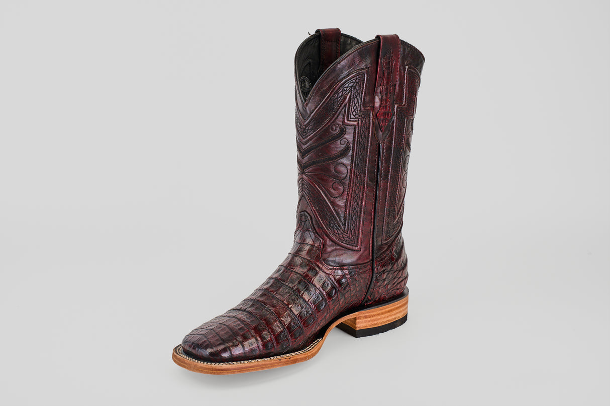 A single Exotic Caiman Belly - Black Cherry boot with a square toe and intricate pattern sits on a light gray background.