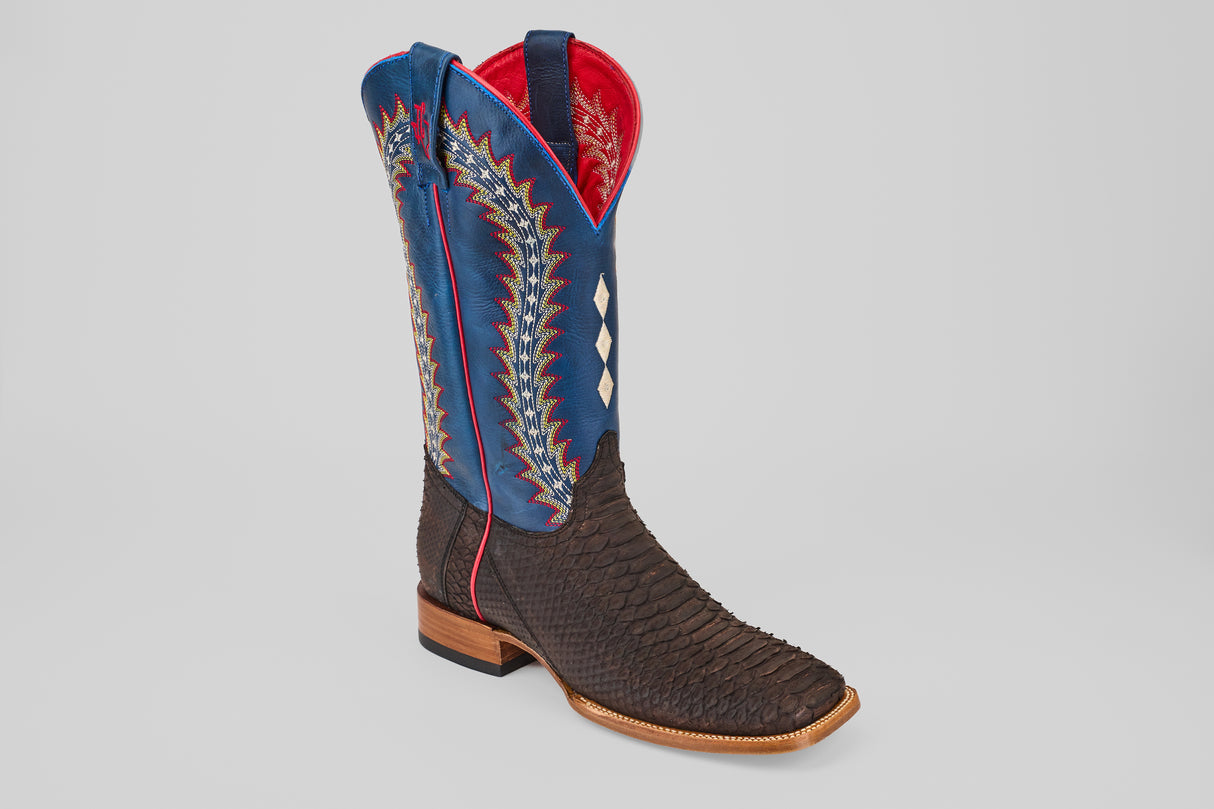 The Morgan - Matte Brown - Square Toe from the Diamond Collection showcases a dark brown textured foot, blue shaft, red trim, colorful zigzag stitching, white diamond inlays, and a classic wooden heel—perfect for men.