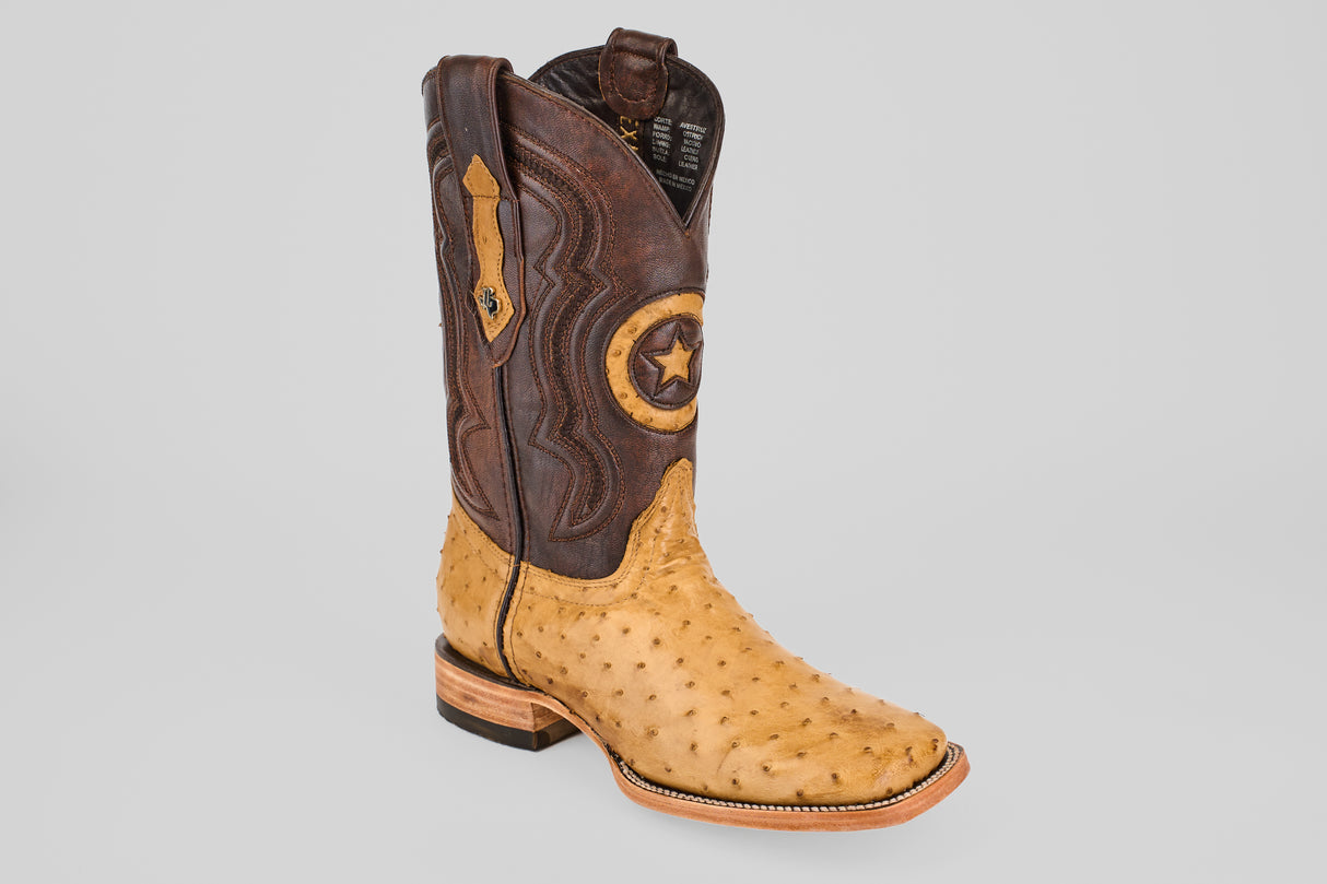 The Exotic Full Quilt Ostrich - Fawn - Square Toe boots feature a tan ostrich leather foot, dark brown shaft, decorative stitching, and a star emblem for a standout Western look.