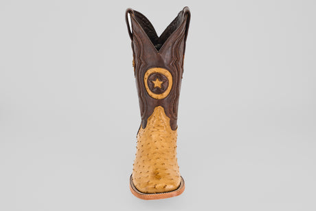The Exotic Full Quilt Ostrich - Fawn - Square Toe boot features a tan ostrich foot, dark brown shaft, and a star emblem patch, offering timeless cowboy style with premium craftsmanship.