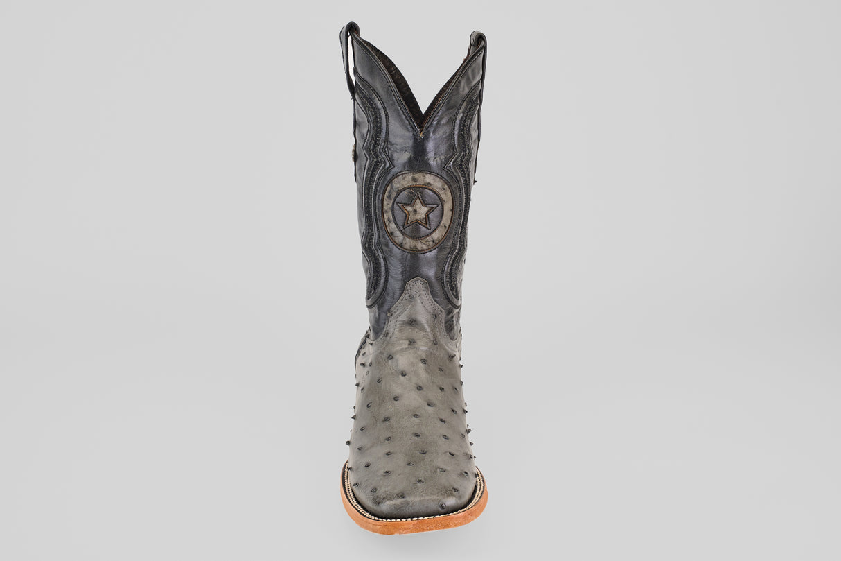 The Exotic Full Quilt Ostrich - Gray - Square Toe cowboy boot features a textured gray full quilt ostrich pattern, tan sole, black stitching, and a circular star emblem on the shaft, displayed against a plain white background.