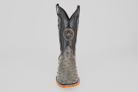 The Exotic Full Quilt Ostrich - Gray - Square Toe cowboy boot features a textured gray full quilt ostrich pattern, tan sole, black stitching, and a circular star emblem on the shaft, displayed against a plain white background.