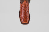 A close-up, top-down view of the Exotic Ostrich - Brandy - Rodeo Toe boot, made from genuine ostrich leather with a square toe and textured surface, set against a plain white background.