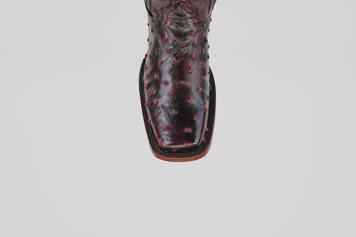 A top view of the Exotic Ostrich - Black Cherry - Rodeo Toe boot showcases its dark, textured ostrich leather and square rodeo toe, all displayed on a plain white background.