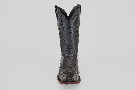 The Exotic Ostrich - Black - Rodeo Toe is a single black cowboy boot featuring a textured, ostrich-style surface and a pointed rodeo toe, shown from the front against a plain white background.