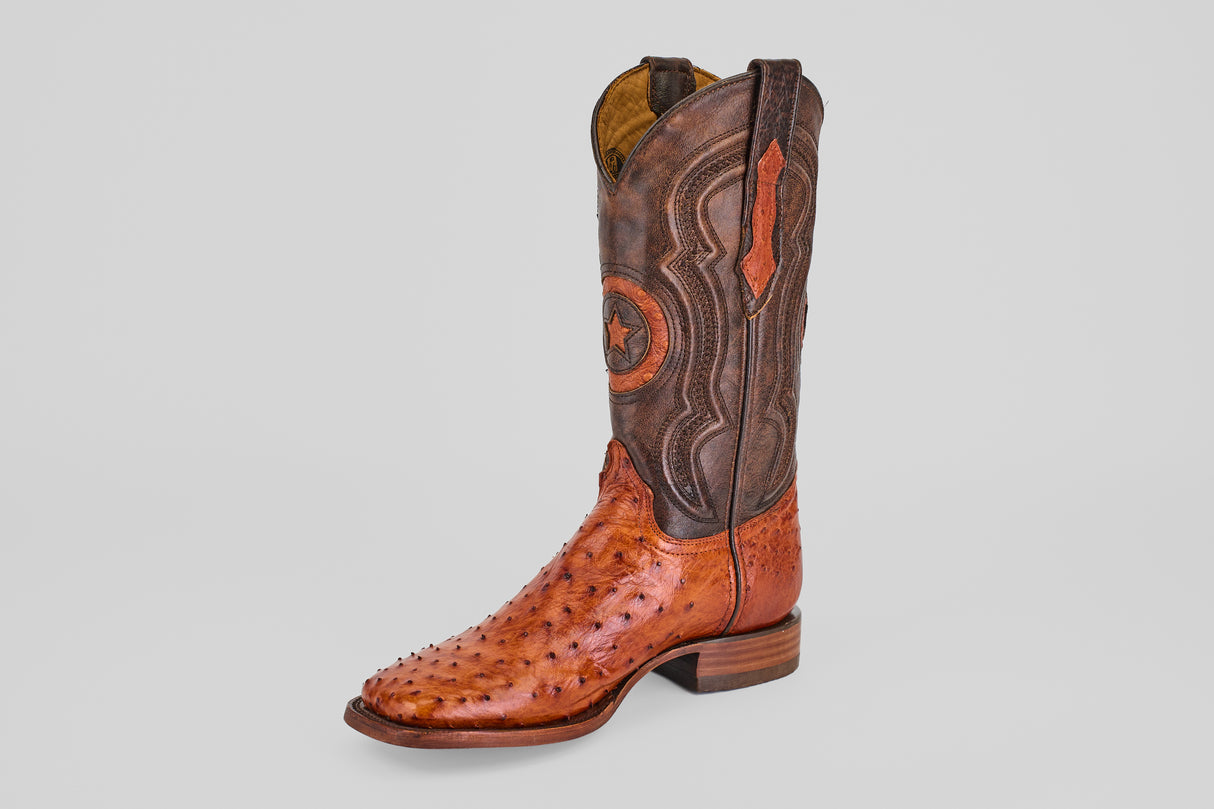 A single Austin - Brandy - Square Toe cowboy boot with a brown textured foot and an ornate, darker leather shaft is displayed on a plain light gray background.