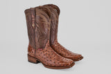 A pair of Austin - Brown - Rodeo Toe high-calf cowboy boots, crafted from avestruz leather with decorative shaft stitching and a square toe, are displayed on a light gray background.