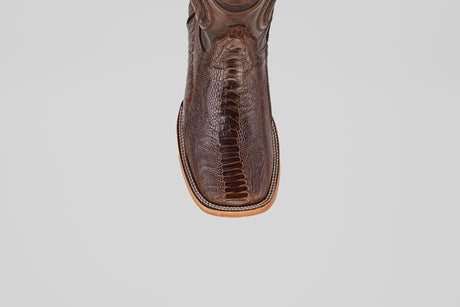 A close-up of the toe on the Austin Leg - Brown - Square Toe cowboy boot, featuring textured ostrich leather and detailed stitching, set against a plain light gray background.