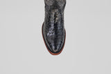 A top-down view of the Tanner - Black - Round Toe cowboy boot in textured Python Negro Oval leather with a reptile-like pattern and brown sole, set against a plain white background.