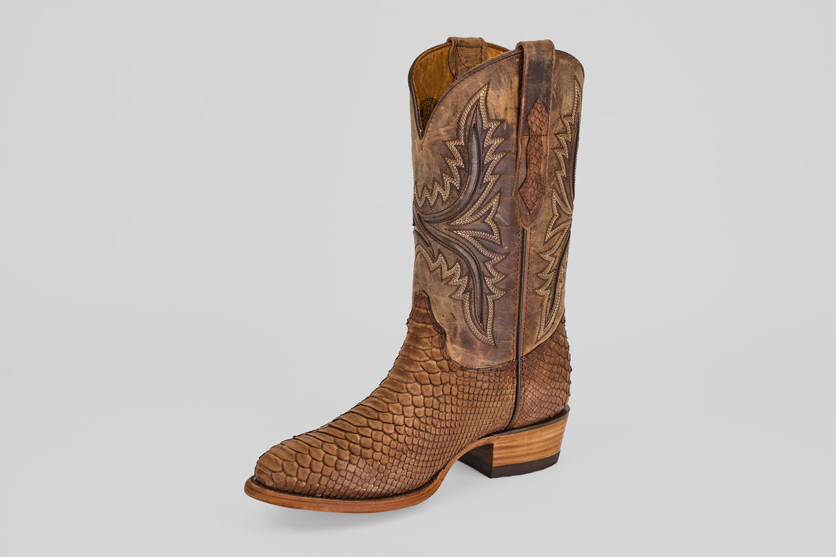 The Tanner - Tamarindo - Round Toe is a single brown cowboy boot with a Python Tamarindo-style textured foot and intricate stitching on the leather shaft, displayed against a plain light background.