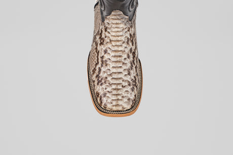 A top-down view of the Tanner - Natural - Square Toe cowboy boot with beige and brown Python Natural snakeskin, featuring a square toe and detailed stitching along the edge of the sole.