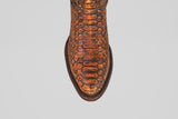 A top-down view of the Tanner – Chestnut – Round Toe boot, showcasing its brown python leather, detailed scale pattern, and dark brown trim around the sole—an ideal choice for western fashion enthusiasts.