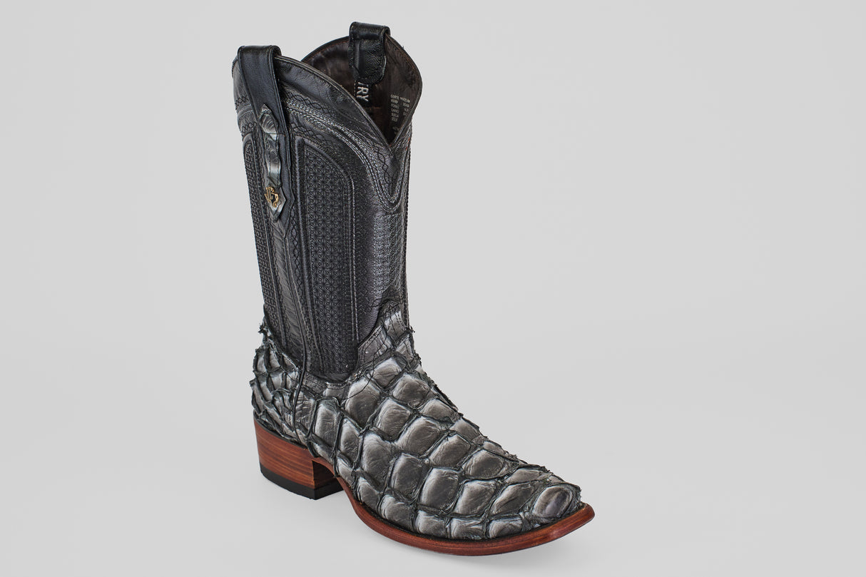 The Conor - Newspaper - Narrow Square Toe boot features black and gray fish leather with a scale-like texture on the foot, a smooth leather shaft, a wooden heel, and a narrow square toe against a plain light gray background.