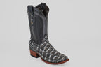 The Conor - Newspaper - Narrow Square Toe boot features black and gray fish leather with a scale-like texture on the foot, a smooth leather shaft, a wooden heel, and a narrow square toe against a plain light gray background.