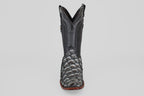 The Conor - Newspaper boot features a black, narrow square toe with a reptile-textured foot, decorative shaft stitching, and a brown sole, shown facing forward against a plain light background.