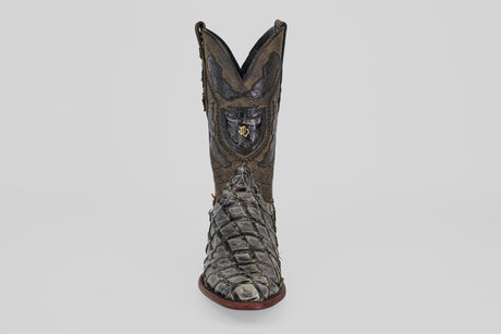 The Conor - Charcoal - Roper Toe is a single ornate cowboy boot made from textured fish leather, featuring a roper toe and bold red sole, displayed upright on a plain light gray background.