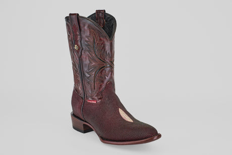 The Ranger – Wine – Round Toe boot is displayed against a plain light gray background, showcasing its maroon color, decorative stitching, textured finish, round toe, and short stacked heel.