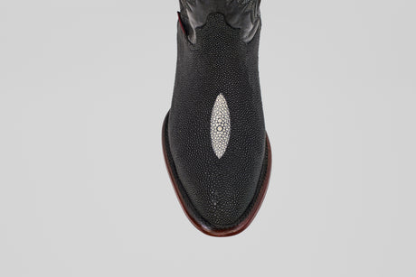 A close-up, top-down view of the Ranger – Black – Round Toe boot, featuring stingray leather with a white oval inlay on the toe and a brown sole, set against a light gray background—perfect for stylish men’s cowboy boot seekers.
