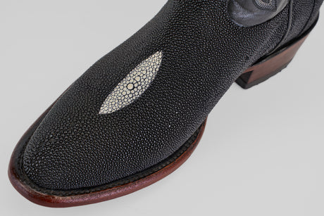 A close-up of the Ranger – Black – Round Toe boot, featuring black stingray leather, a smooth oval white accent, and a wooden sole—ideal for anyone seeking unique, stylish black round toe boots.