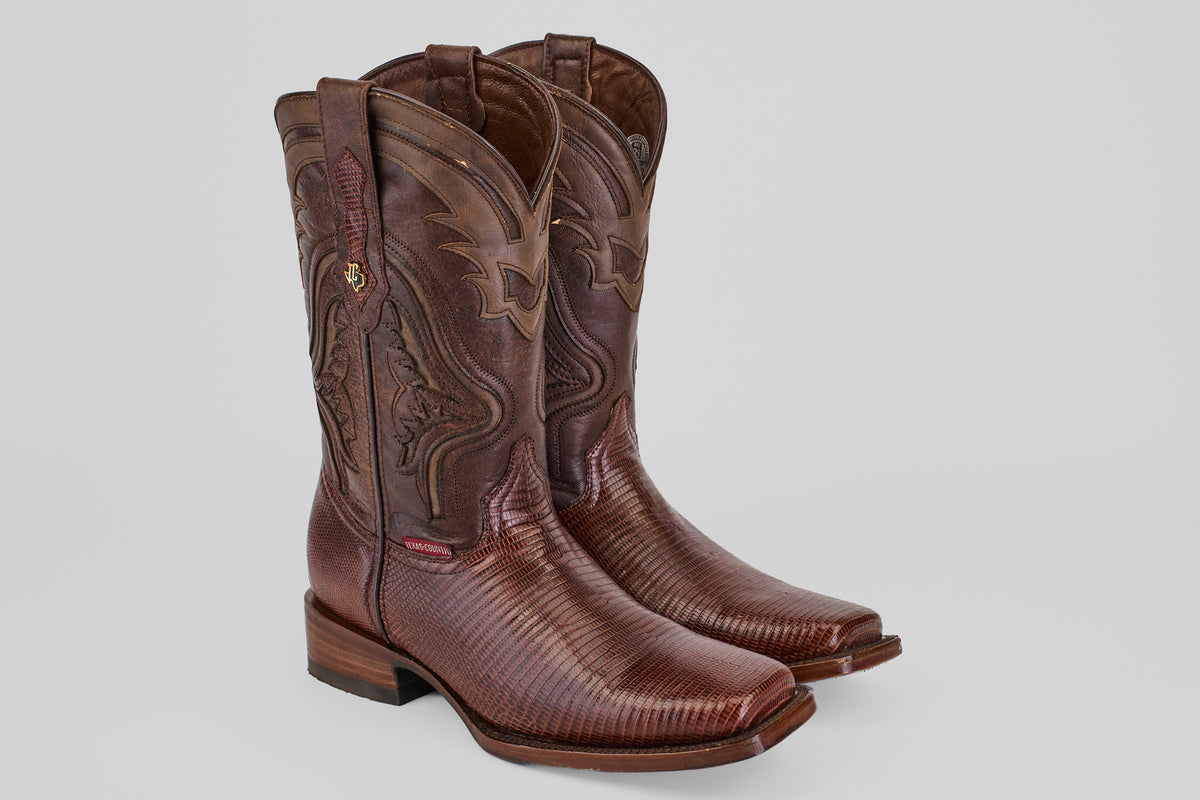 A pair of Blaze – Brown – Rodeo Toe cowboy boots crafted from genuine lizard leather with decorative stitching, a textured finish, square toes, and low stacked heels, displayed side by side on a plain light background.