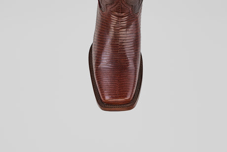 The Blaze – Brown – Rodeo Toe cowboy boot, made from genuine lizard leather with a textured finish and square toe, is shown from above against a plain light gray background, highlighting its refined western style.