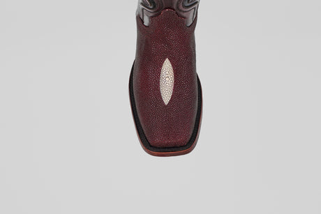 A close-up, top-down view of the Ranger – Wine – Rodeo Toe cowboy boot, showcasing its maroon stingray leather with a white diamond accent and classic rodeo toe, set against a plain light gray background.
