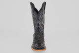 A single Ostrich Black - Embossed Leather - Square Toe (E424) cowboy boot with textured details and decorative stitching, shown from the front on a plain light gray background. Features a light brown sole and slightly pointed toe.