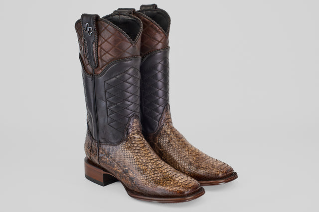 The Tanner Platinum - Dune - Square Toe (Imperial) boots feature patterned brown leather shafts, textured light brown python vamps, and low stacked heels, all showcased against a plain background.