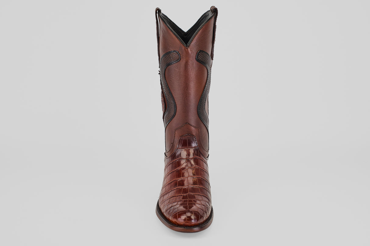 The James Platimun - Dark Cogñac boot with a glossy, textured finish and classic roper toe stands upright, facing forward against a plain light gray background.