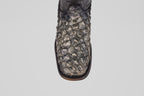 A close-up of the Conor Platinum - Newspaper - Square Toe (Diamond) cowboy boot, featuring dark, textured crocodile-patterned leather and a brown edge, displayed against a plain white background.