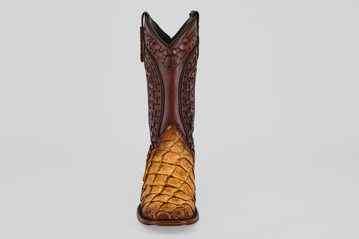 The Conor Platinum - Buttercup - Square Toe (Herradura) boot features a dark brown, intricately tooled upper and a light brown pirarucu-textured lower front, shown from the front against a plain gray background.