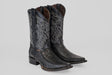 A pair of Python Black - Embossed Leather - Versy Toe (E202) cowboy boots with intricate silver stitching, pointed toes, and stacked heels is displayed on a plain light gray background.