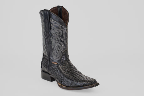 A single Python Black - Embossed Leather - Versy Toe (E202) boot with intricate silver stitching, textured foot, square toe, low heel, and dual pull tabs is displayed on a light gray background.