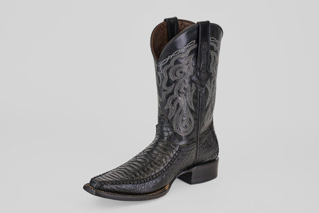 The Python Black - Embossed Leather - Versy Toe (E202) cowboy boot features intricate silver embroidery on the shaft and a textured, pointed toe, shown on a light gray background—ideal for bold western style enthusiasts.