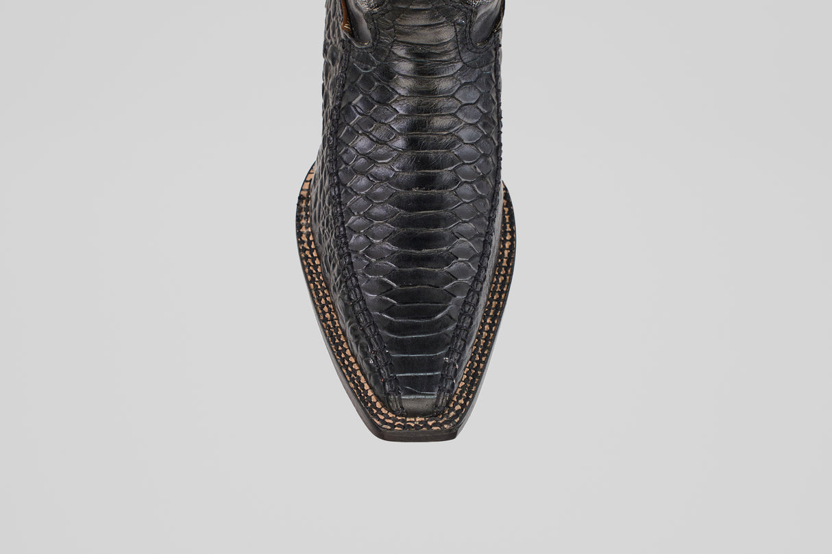 Close-up top view of the Python Black - Embossed Leather - Versy Toe (E202) cowboy boot, showcasing its square toe and detailed brown stitching along the sole, set against a plain light background for authentic western style.