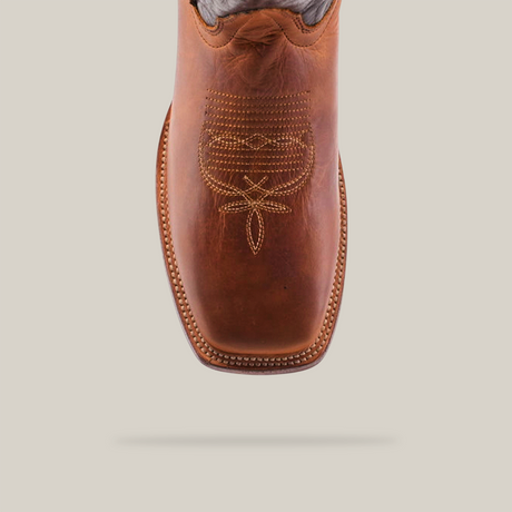 Top view of the Cater Honey - Square Toe, a brown leather cowboy boot made from premium cowhide with decorative stitching on the toe and intricate detailing, set against a white background.