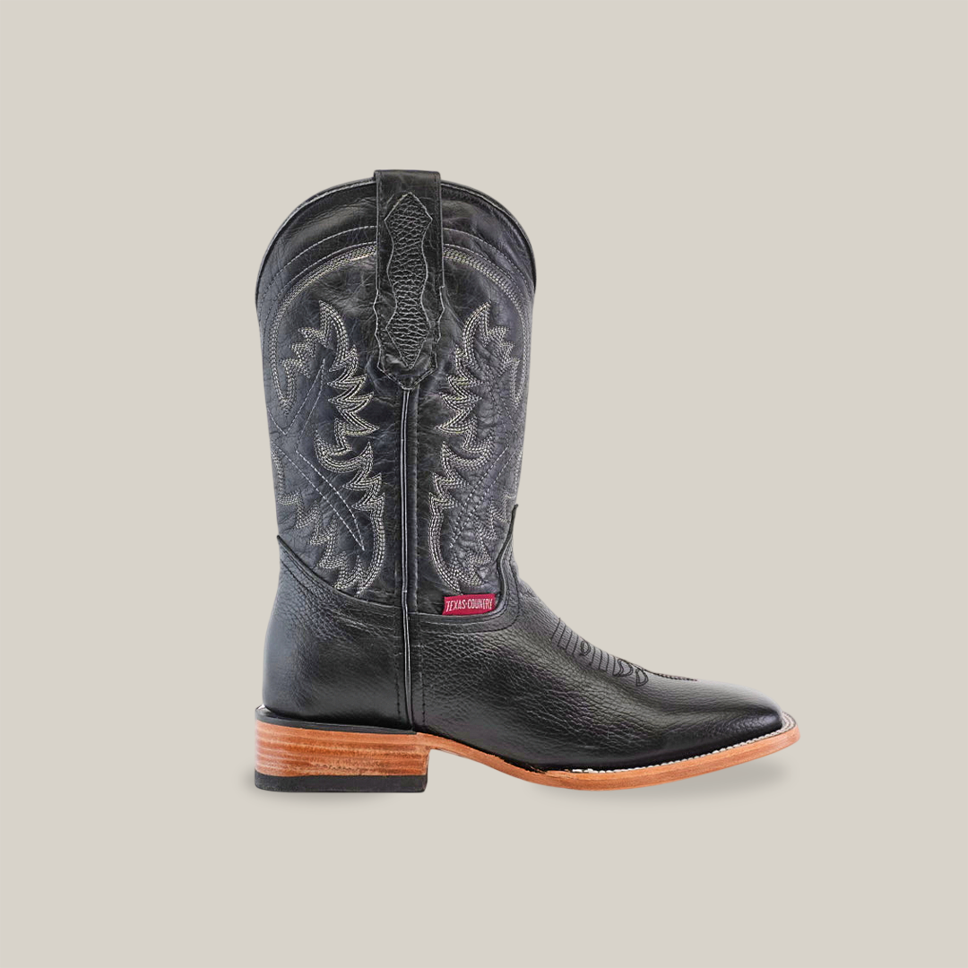 Introducing the Barcelona Black - Square Toe boots: exquisite black leather cowboy boots handcrafted with intricate embroidery on the shaft, featuring a sturdy wooden heel and a light brown sole. Made from premium cowhide, these standout boots look stunning against a plain white background.