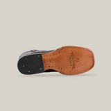 Bottom view of the Lizard Print Black - Square Toe shoe featuring a smooth light brown leather sole made from premium cowhide with the Texas Country logo. It has a black heel with metal accents, displayed against a white background.