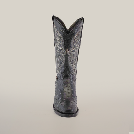 The Karoo Ostrich Print Black boot, with a round toe and intricate white stitching on a rich ostrich print texture, is set against a plain white background.