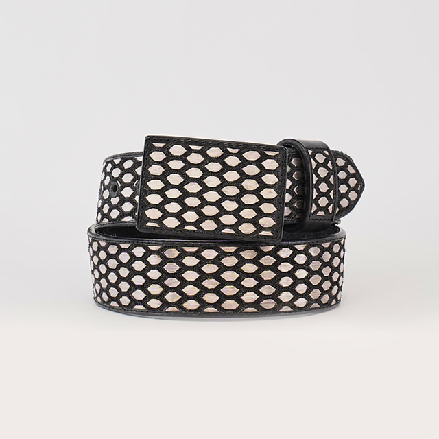 The Artisanal Handmade Silver Belt Hexagon features a luxurious black and white geometric pattern with hexagonal shapes and silver thread embroidery. The handcrafted belt showcases a unique design, complemented by a rectangular buckle of the same pattern against a plain white backdrop.