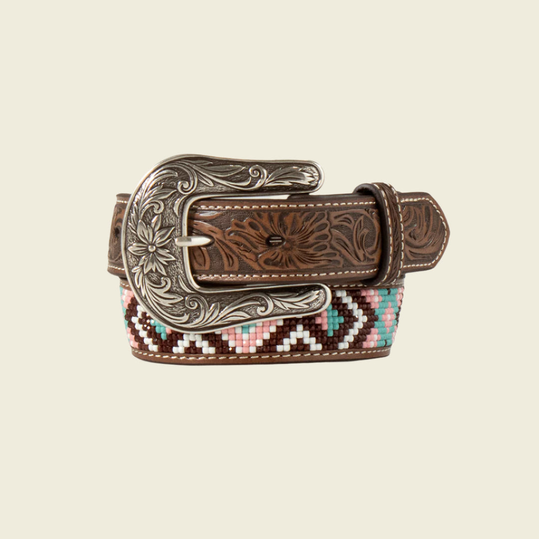 The Angel Ranch Western Belt Girls Beaded Inlay Embossed Billet - D130004497 features intricate floral engravings on the silver buckle and strap, with a colorful beaded geometric pattern in pink, turquoise, brown, and white on the underside, capturing Western-inspired designs.