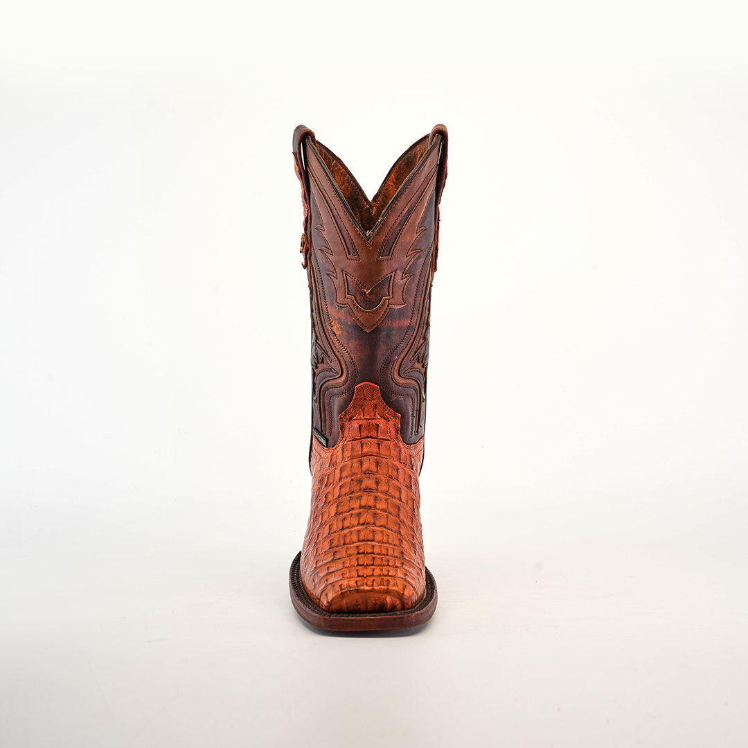 Front view of a single Exotic Caiman Hornback - Brandy - Rodeo Toe boot made from genuine caiman leather, showcasing intricate stitching and a woven texture on the foot part, set against a plain white background.