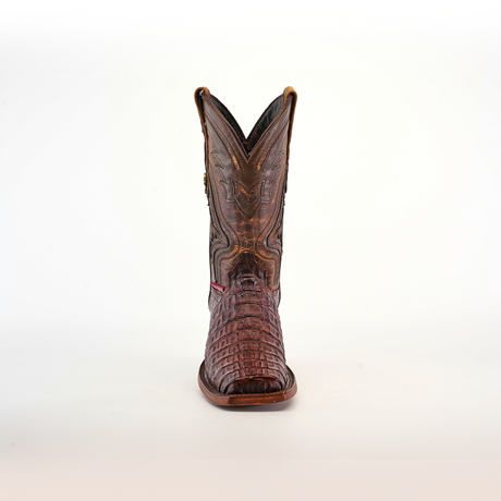 The Exotic Caiman Hornback boot showcases a pointed rodeo toe and a high shaft with exquisite stitching, crafted from brown caiman leather with intricate hornback details, and is displayed against a plain white background.