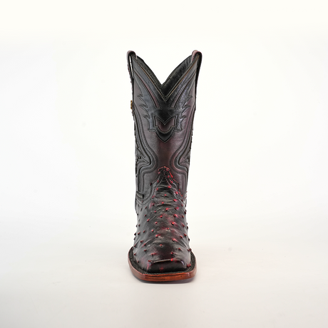 The Exotic Ostrich - Black Cherry cowboy boot boasts a genuine ostrich leather construction with intricate stitching and red accents. Displayed against a white background, it highlights its craftsmanship and unique rodeo toe design.