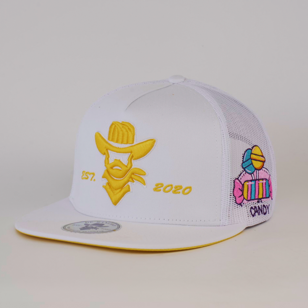 The De Rancho Cap Candy White features a white baseball design with yellow embroidery of a cowboy hat and beard, EST. 2020 text, candy graphics on the side with CANDY, and a white mesh back paired with a yellow brim underside.