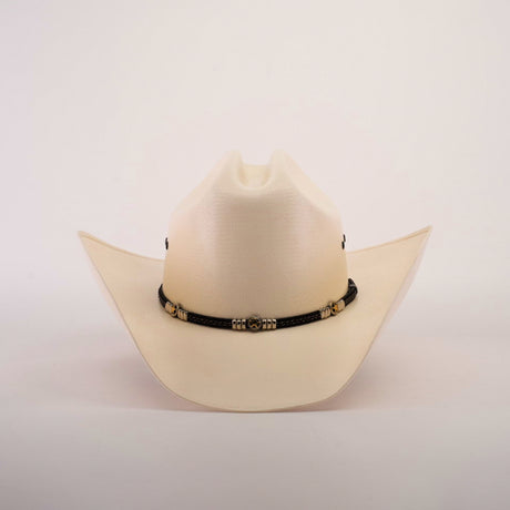 The 500X Country Straw Hat features a plain white design with a wide brim, crafted from premium materials, and adorned with a black band featuring ornate gold accents.