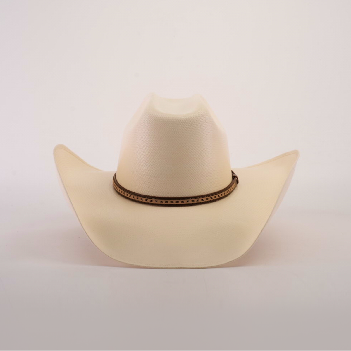 The 1000X Bull Straw Hat, in cream with a brown band, offers durability for outdoor adventures. It is showcased on a plain white background.