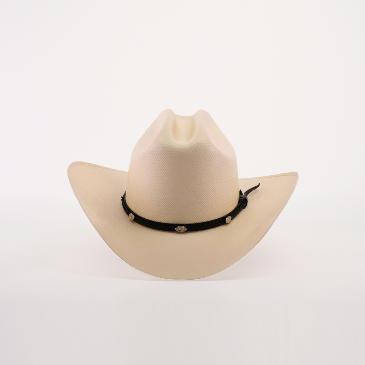 Introducing the 500X Sinaloa Straw Hat, a beige cowboy hat with timeless style and unmatched quality. It features a wide brim and a black decorative band adorned with round golden ornaments, beautifully set against a plain white background.