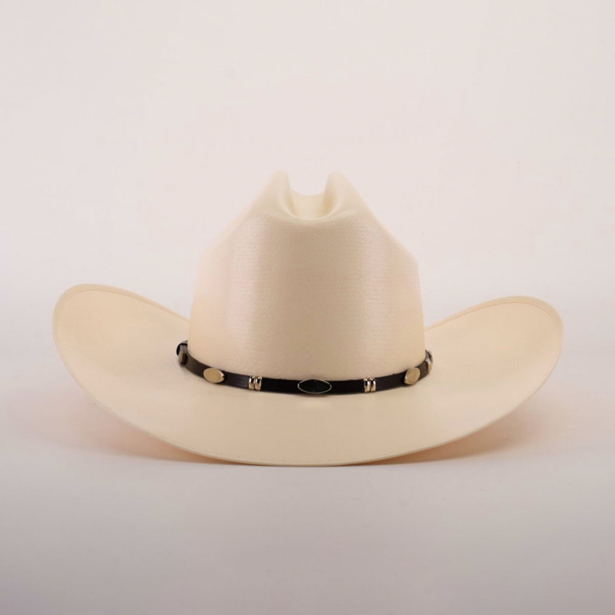 The 5000x Sinaloa Straw Hat is a beige cowboy hat featuring a black band with metal accents. Its high crown and wide brim highlight exceptional craftsmanship, set against a plain white background.