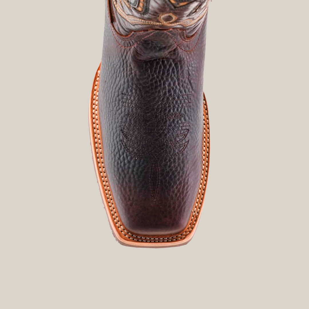 Top view of the Cheyenne Chocolate - Slip Resistant Sole Rodeo Toe cowboy boot, featuring intricate stitching on the square toe. Crafted from premium cowhide, it showcases decorative patterns and detailed stitching around a slip-resistant sole with a shiny leather finish.